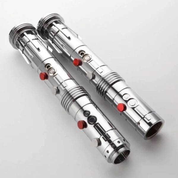 Two silver and red lightsaber 's on a white surface.